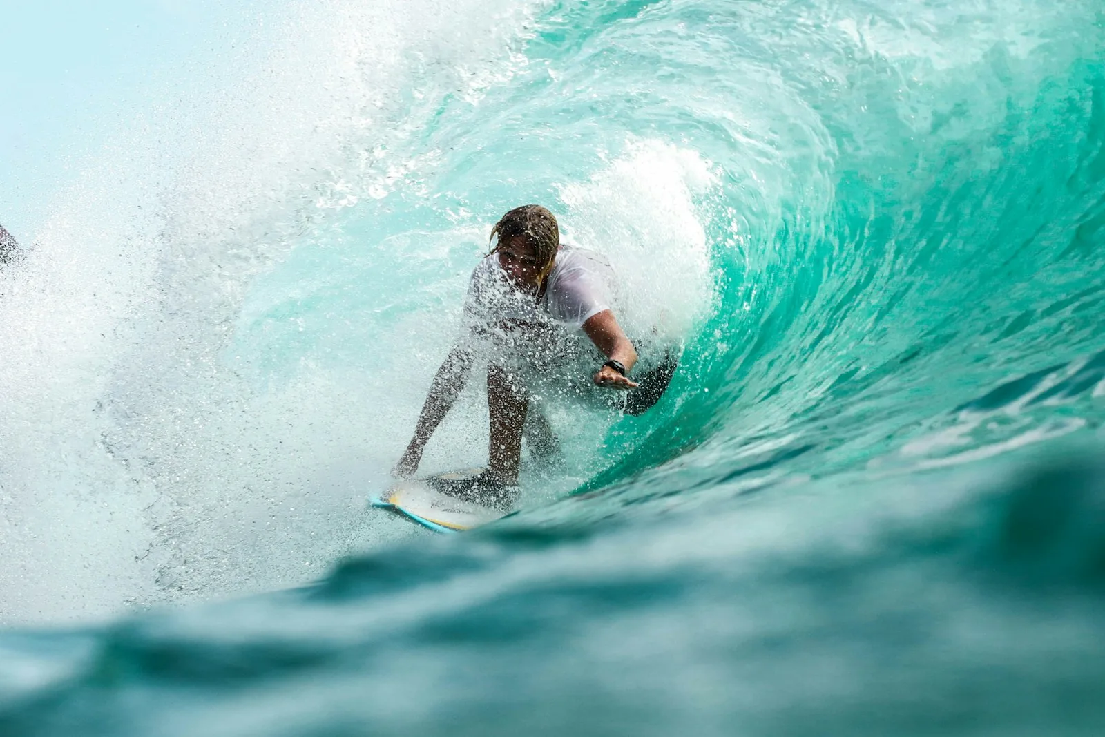Surfer riding a wave at a tropical beach